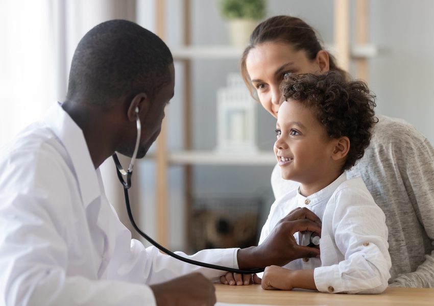 African American male pediatrician with stethoscope listening to lung and heart sound of little boy sitting on mother lap, physician checkup at home or in hospital, children medical insurance care; Shutterstock ID 1504547801; purchase_order: 1234; job: ; client: ; other:
